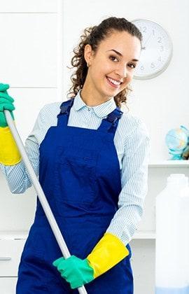 Young Girl Looking At Camera holding a mop in her hands